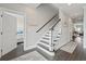 Staircase with dark wood steps, white risers, and decorative coastal themed decor at 204 33Rd Ave. N, North Myrtle Beach, SC 29582