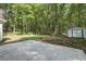 Large backyard with patio area and mature trees, perfect for outdoor living and entertaining at 203 Deer Trace, Myrtle Beach, SC 29588
