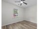Bright bedroom featuring modern ceiling fan, gray wood-look flooring and view to the outside at 203 Deer Trace, Myrtle Beach, SC 29588