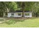 Charming single-story home with white siding, black shutters, and a well-maintained front lawn at 203 Deer Trace, Myrtle Beach, SC 29588