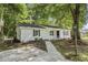 Charming single-story home with white siding, black shutters, and inviting front porch at 203 Deer Trace, Myrtle Beach, SC 29588
