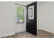 An open black front door with a window lets light into this updated home with wood flooring at 203 Deer Trace, Myrtle Beach, SC 29588