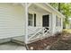 Close-up of the cozy front porch with white railing and siding, offering a welcoming entrance at 203 Deer Trace, Myrtle Beach, SC 29588