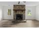 Bright living room with a stunning stone fireplace, ceiling fan, and modern vinyl plank flooring at 203 Deer Trace, Myrtle Beach, SC 29588