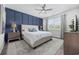 Cozy bedroom featuring an accent wall, comfortable bedding, and natural light for a relaxing retreat at 205 Longside Ct., Little River, SC 29566