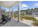 Inviting front porch with decorative landscaping, black rocking chairs, and neighborhood views at 205 Longside Ct., Little River, SC 29566