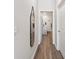 Hallway view leading to a bathroom with wood-look flooring and modern decor for a cohesive design at 205 Longside Ct., Little River, SC 29566