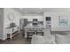 Modern kitchen with granite countertop island and stainless steel appliances open to living space at 205 Longside Ct., Little River, SC 29566