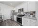 Beautiful kitchen with white cabinetry, granite counters, and stainless steel appliances at 205 Longside Ct., Little River, SC 29566