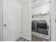 Laundry room with stacked washer/dryer, and patterned floor at 205 Longside Ct., Little River, SC 29566