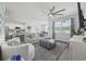 Open-concept living room with a view of the kitchen, featuring plush seating and modern decor elements at 205 Longside Ct., Little River, SC 29566