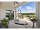 Covered patio with wicker furniture and a scenic view of the pond at 205 Longside Ct., Little River, SC 29566