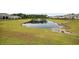Community pond featuring a fountain, surrounded by lush green grass, offering a serene view at 205 Longside Ct., Little River, SC 29566