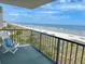 Balcony showing a chair and beach views, plus a view of other balconies under a partly cloudy sky at 2101 S Ocean Blvd. # A-4, North Myrtle Beach, SC 29582