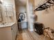 Bathroom view showing a vanity with round mirror, and a walk in closet with shelving and hanging space at 2101 S Ocean Blvd. # A-4, North Myrtle Beach, SC 29582