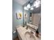 Bathroom showcasing a marbled vanity, decorative fixtures, and a large mirror for a bright, spacious feel at 2101 S Ocean Blvd. # A-4, North Myrtle Beach, SC 29582