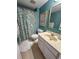 Bathroom with a tiled floor and walls, a shower with a floral curtain, and a vanity sink at 2101 S Ocean Blvd. # A-4, North Myrtle Beach, SC 29582