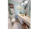 Bathroom with blue walls, featuring a marble-style vanity, toilet, and framed art at 2101 S Ocean Blvd. # A-4, North Myrtle Beach, SC 29582