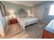 Bright bedroom featuring a king-sized bed, side tables with lamps, and an attractive decorative headboard at 2101 S Ocean Blvd. # A-4, North Myrtle Beach, SC 29582