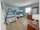 Well-lit bedroom featuring a bunk bed, a standard bed, side tables, and a mirror at 2101 S Ocean Blvd. # A-4, North Myrtle Beach, SC 29582