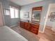Bedroom showcasing a bed with a decorative dresser, a mirror, and a window at 2101 S Ocean Blvd. # A-4, North Myrtle Beach, SC 29582