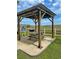 Outdoor gazebo with picnic table and grill overlooking grassy dunes near the beach at 2101 S Ocean Blvd. # A-4, North Myrtle Beach, SC 29582