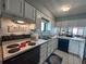 Bright kitchen with white cabinets, and stainless steel appliances at 2101 S Ocean Blvd. # A-4, North Myrtle Beach, SC 29582