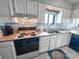 Bright kitchen featuring white cabinets, stainless steel sink, and beach decor at 2101 S Ocean Blvd. # A-4, North Myrtle Beach, SC 29582