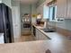 Kitchen featuring modern appliances, white cabinets and a view from the breakfast bar at 2101 S Ocean Blvd. # A-4, North Myrtle Beach, SC 29582