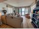 Bright living room featuring a comfortable sectional sofa and a sliding door to the ocean view at 2101 S Ocean Blvd. # A-4, North Myrtle Beach, SC 29582