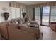 Comfortable living room with couch and balcony access, and views of the beach at 2101 S Ocean Blvd. # A-4, North Myrtle Beach, SC 29582