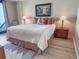 Bright bedroom with a king bed, nightstands, and ocean view access at 2101 S Ocean Blvd. # A-4, North Myrtle Beach, SC 29582