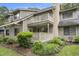 Beautiful exterior view of a multi-level townhome with private balconies, lush landscaping and natural light at 213 Westleton Dr. # 16B, Myrtle Beach, SC 29572