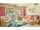 Comfortable living room with large windows offering views of the outdoor deck at 213 Westleton Dr. # 16B, Myrtle Beach, SC 29572