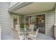 Cozy outdoor patio features a round table with seating for four, perfect for relaxing and enjoying the surroundings at 213 Westleton Dr. # 16B, Myrtle Beach, SC 29572