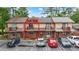 View of unit 218 featuring a charming balcony and well-manicured landscaping in a townhome complex at 218 Waccamaw Village Dr. # 218, Myrtle Beach, SC 29579