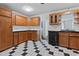 Traditional kitchen with checkered floors, wood cabinets and black appliances at 218 Waccamaw Village Dr. # 218, Myrtle Beach, SC 29579