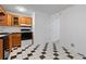 Cozy kitchen with black and white tile floors and natural wood cabinets at 218 Waccamaw Village Dr. # 218, Myrtle Beach, SC 29579