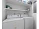Laundry room features a washer and dryer with shelves for storing laundry supplies at 218 Waccamaw Village Dr. # 218, Myrtle Beach, SC 29579