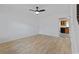 Living room with wood-look floors, ceiling fan, and view into kitchen with black and white tile floor at 218 Waccamaw Village Dr. # 218, Myrtle Beach, SC 29579