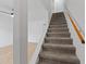 Carpeted staircase with wooden handrail leading to the upper level of the home at 218 Waccamaw Village Dr. # 218, Myrtle Beach, SC 29579