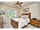 Comfortable bedroom with a wooden bed frame, ceiling fan, and a window view at 2180 Waterview Dr. # 635, North Myrtle Beach, SC 29582