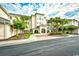 Beautiful building exterior features manicured landscaping, sidewalks, and palm trees against a cloudy sky at 2180 Waterview Dr. # 635, North Myrtle Beach, SC 29582