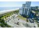 Beach condo building featuring an asphalt parking lot near the ocean at 2310 N Ocean Blvd. # 1107, Myrtle Beach, SC 29577
