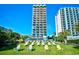 A view of the condo building surrounded by manicured lawn and lounge seating at 2310 N Ocean Blvd. # 1107, Myrtle Beach, SC 29577