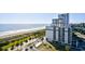 Aerial view of an oceanfront building with a pool, beach access and landscaping at 2310 N Ocean Blvd. # 1107, Myrtle Beach, SC 29577