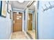 Hallway with mirror, tiled floor, and artwork at 2310 N Ocean Blvd. # 1107, Myrtle Beach, SC 29577