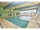 An indoor pool area with seating, signs, and large windows at 2310 N Ocean Blvd. # 1107, Myrtle Beach, SC 29577