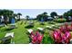 Lawn area with tables, chairs, umbrellas, and tropical flowers at 2310 N Ocean Blvd. # 1107, Myrtle Beach, SC 29577