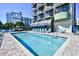 Clear outdoor pool with tables and chairs available for relaxing at 2310 N Ocean Blvd. # 1107, Myrtle Beach, SC 29577
